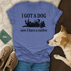 Blue t-shirt with text "I GOT A DOG now I have a curfew" and dog graphic.