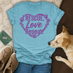 Light blue t-shirt with "Rescue. Love. Repeat." in a heart of paw prints.