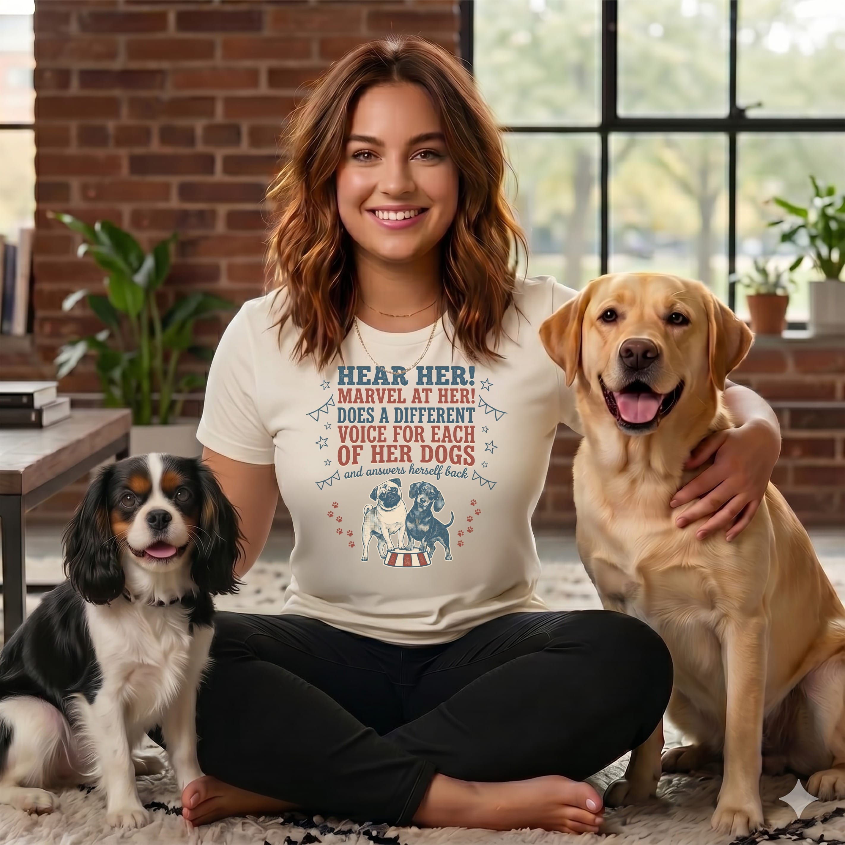 Woman in t-shirt with dogs. Text on shirt: "Hear Her! Marvel At Her! Does A Different Voice For Each Of Her Dogs And Answers Herself Back."