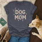 Dark gray t-shirt with "DOG MOM" text made of seashells and paw prints.