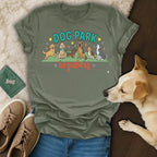 Dog Park Regulars t-shirt with cartoon dogs and paw print accents.