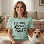 Woman wearing a mint green t-shirt with "Rescue Dog Rescued Me Back" text.