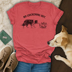 Red t-shirt with "NO CHICKENING OUT." text and dog with chickens graphic.