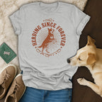 Grey t-shirt with "Herding Since Forever" text and dog illustration.