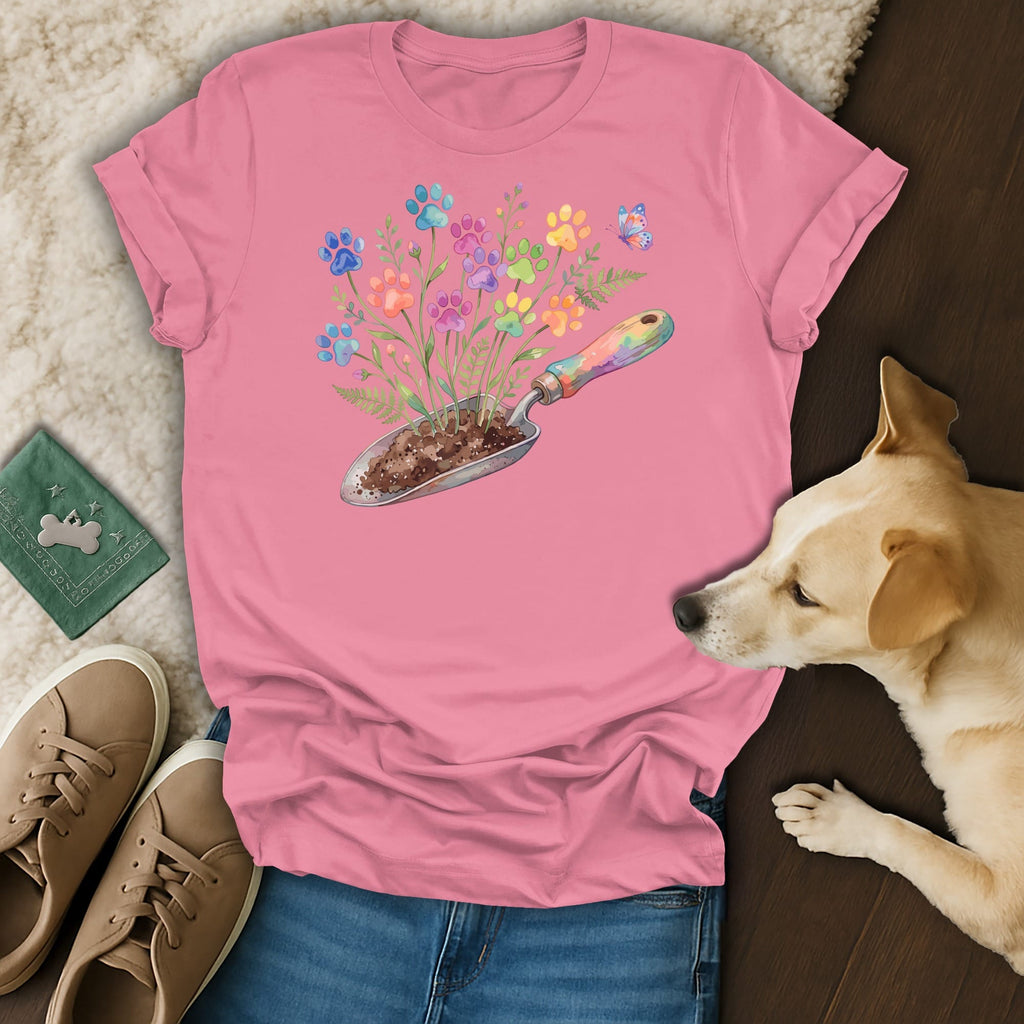 Pink t-shirt with colorful paw print flowers growing from a gardening trowel.