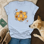 Light blue crewneck t-shirt featuring a honeycomb graphic with paw prints, surrounded by bees and flowers.