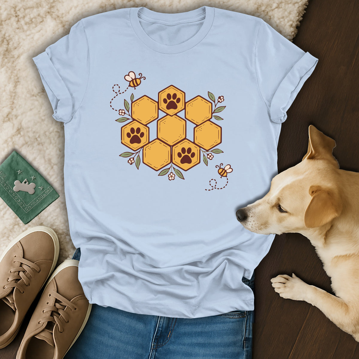 Light blue crewneck t-shirt featuring a honeycomb graphic with paw prints, surrounded by bees and flowers.