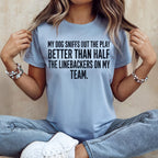 Light blue t-shirt with "My dog sniffs out the play better than half the linebackers on my team" text.