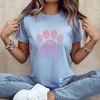 Pale blue t-shirt with a pink ombre paw print graphic made of "Bestie" text.