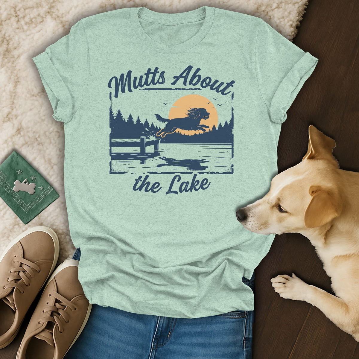 Light blue t-shirt with "Mutts About the Lake" graphic of dog jumping over water.