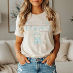 Cream t-shirt with graphic of a dog and text "All I Need Is The Beach".