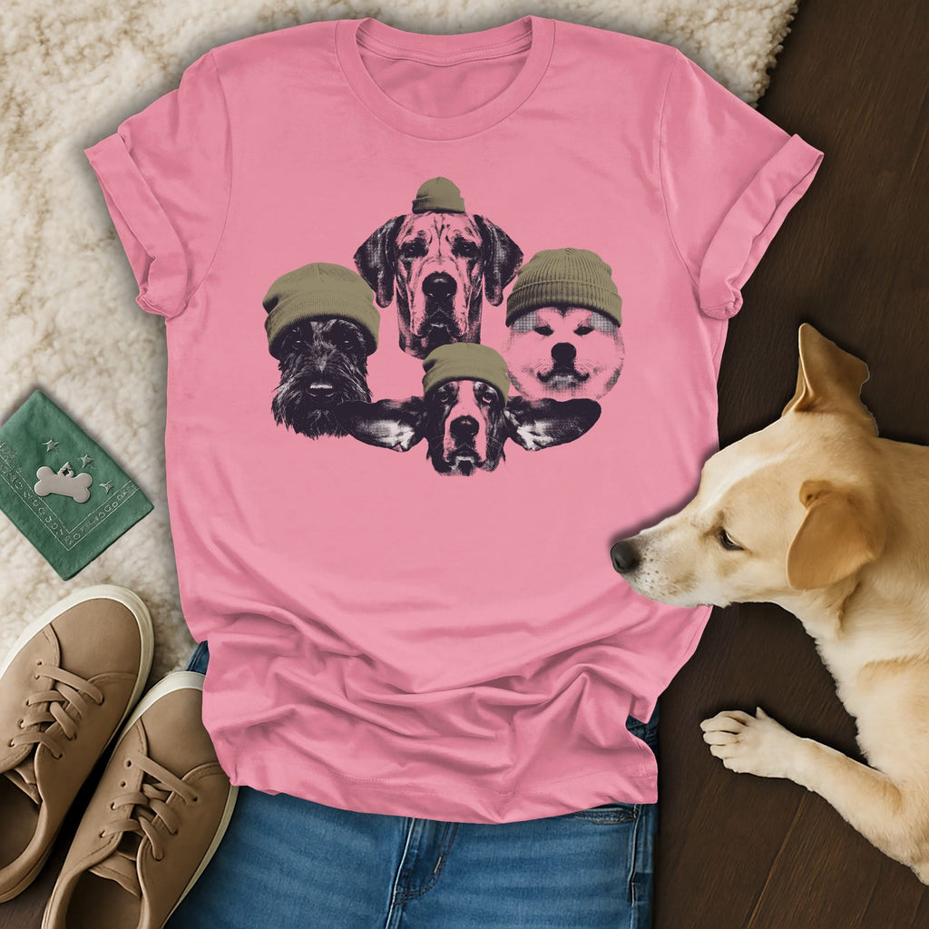 Pink t-shirt with a graphic of four dog heads wearing beanies.