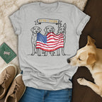 Three dogs hold an American flag; shirt text reads "1776-2026 USA 250".