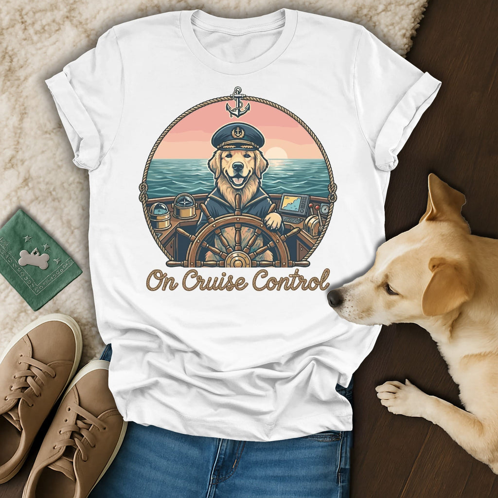 T-shirt graphic of a golden retriever captain on a ship's wheel with "On Cruise Control" text.