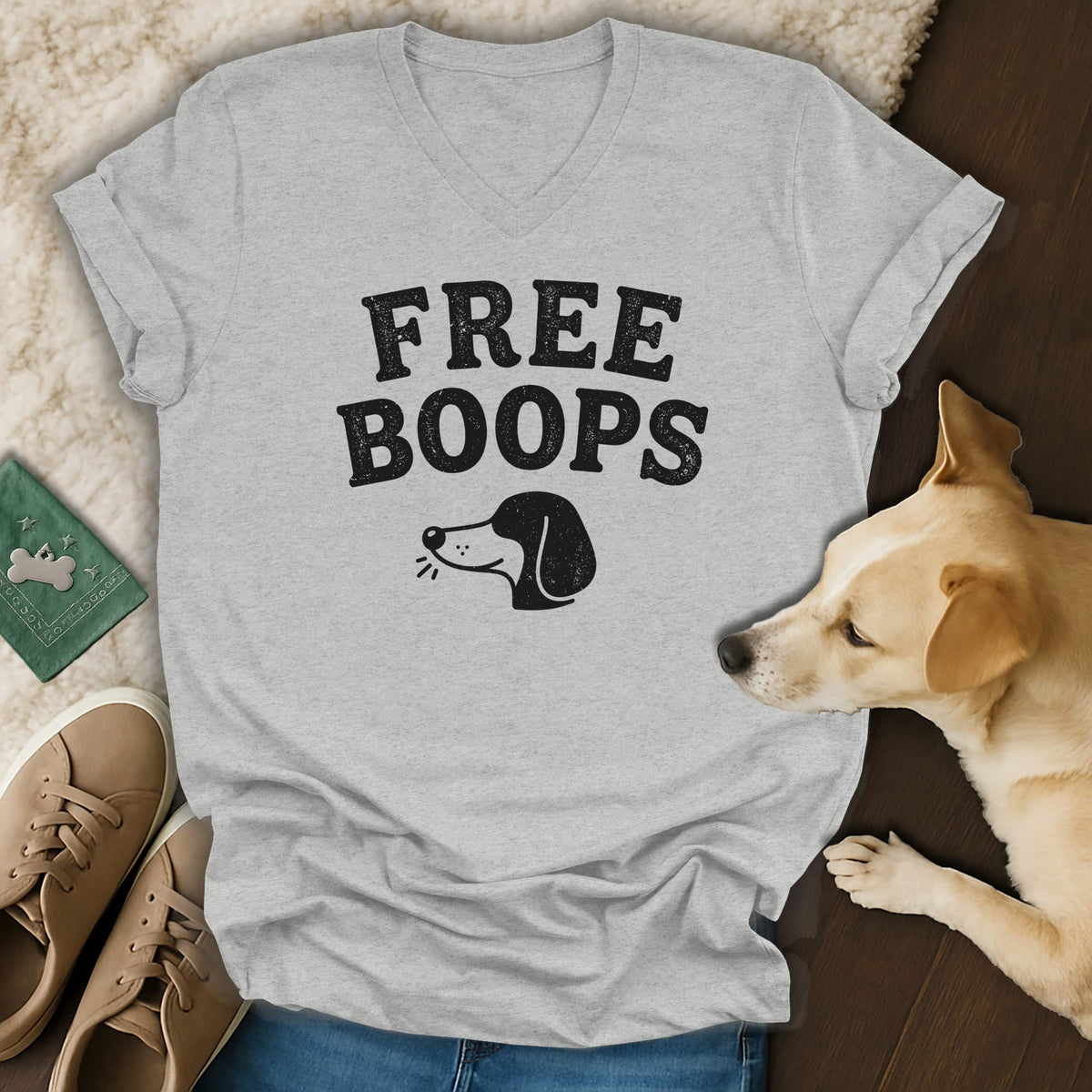 Gray t-shirt with "FREE BOOPS" text and dog illustration, near a dog.