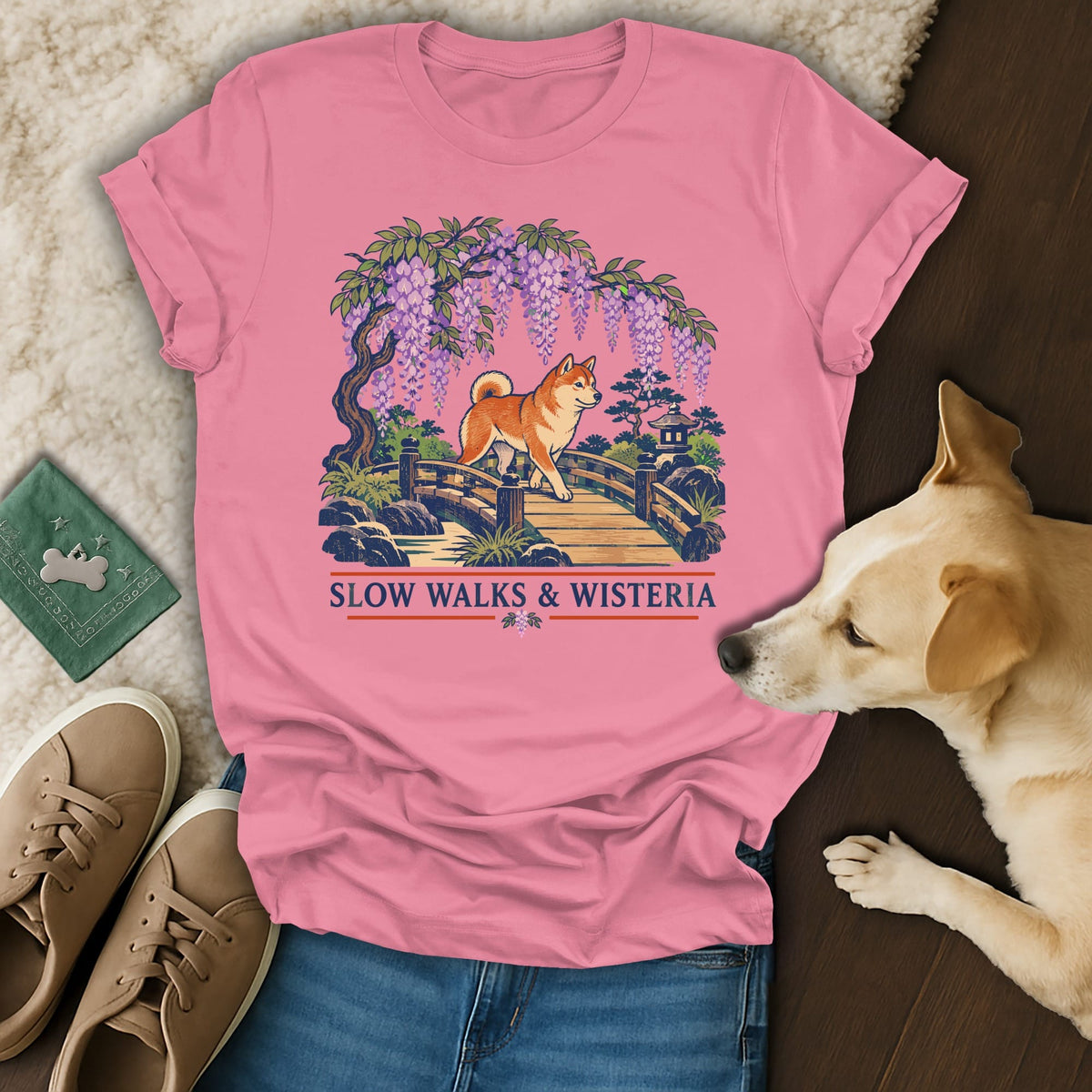 Pink t-shirt featuring a graphic of a Shiba Inu on a bridge beneath wisteria, with the text Slow Walks & Wisteria.