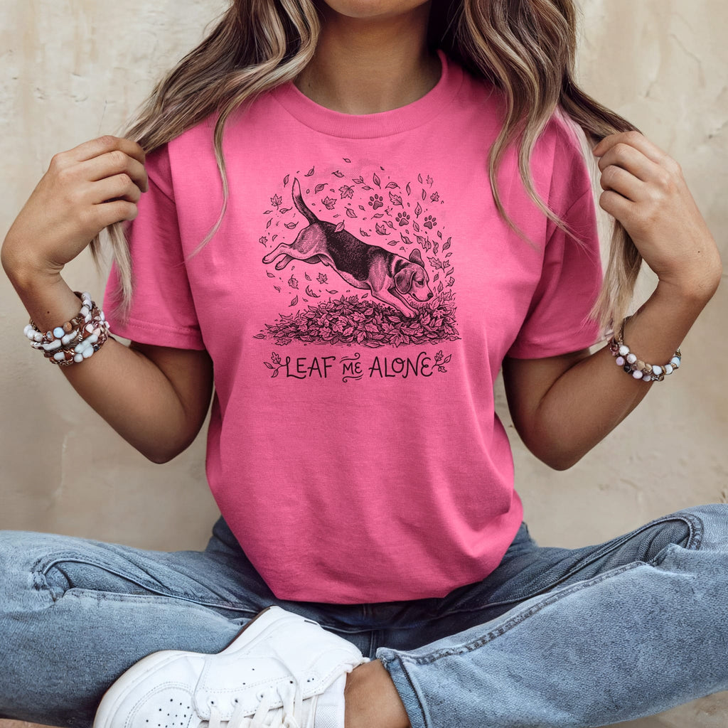 T-shirt with beagle jumping through autumn leaves and text "Leaf Me Alone."