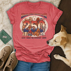 T-shirt with "America Feels Groovy 250 1776-2026 Keep On Woofin'" and dogs.