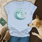 Light blue t-shirt with a stylized wave dog graphic and paw prints.