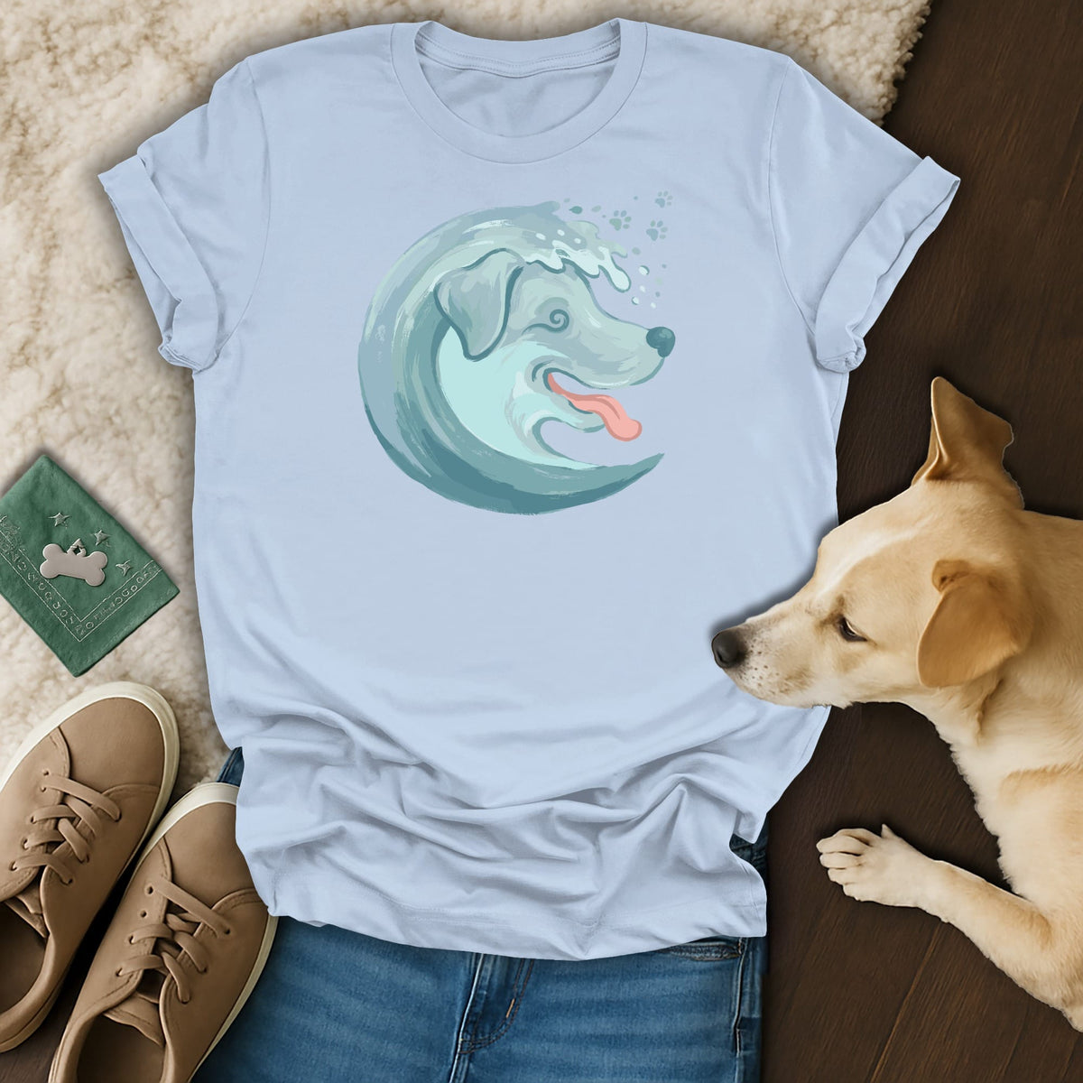Light blue t-shirt with a stylized wave dog graphic and paw prints.