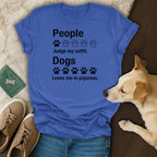 Blue t-shirt with black text and paw prints: "People Judge my outfit. Dogs Loves me in pajamas."