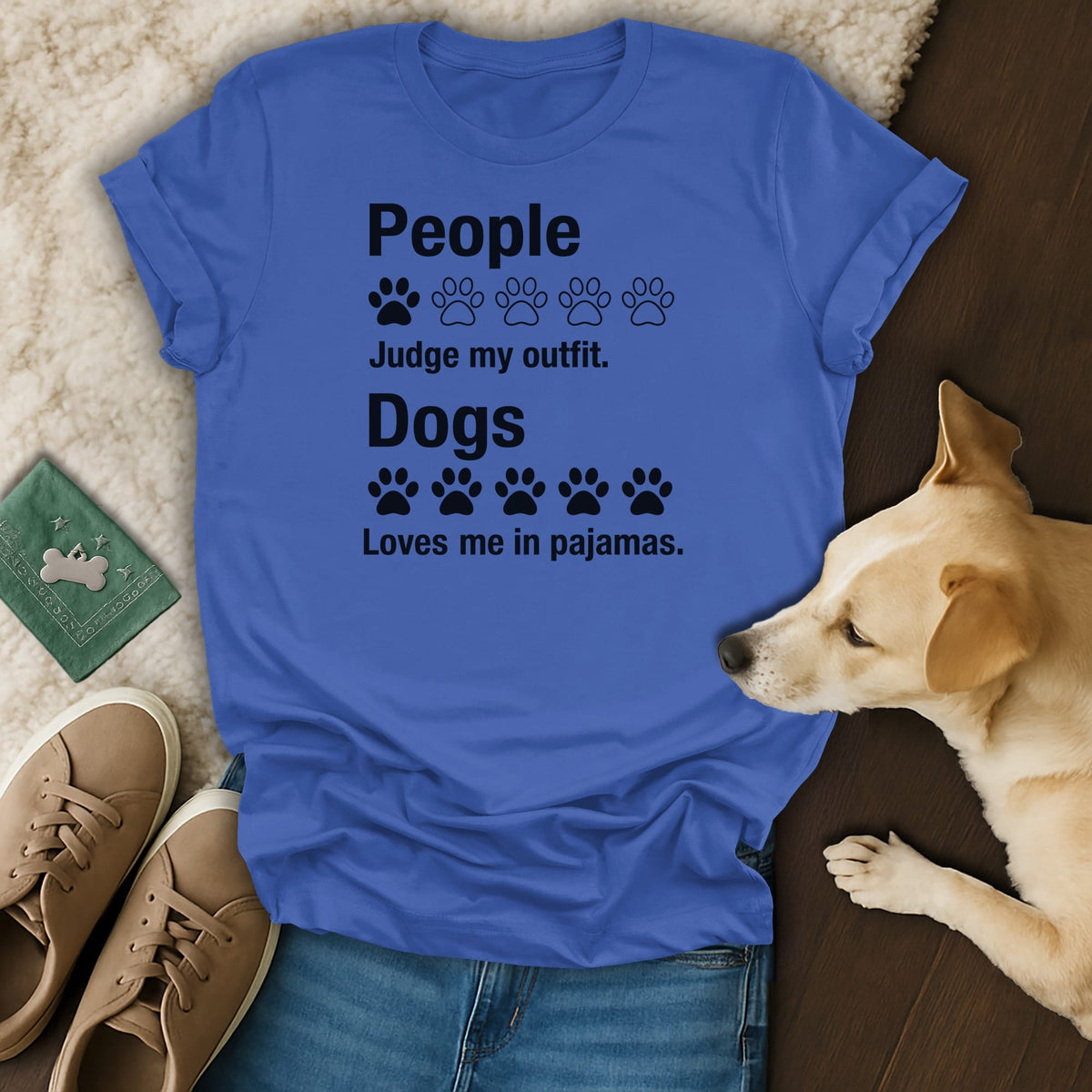 Blue t-shirt with black text and paw prints: "People Judge my outfit. Dogs Loves me in pajamas."
