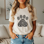 Cream t-shirt with black paw print graphic saying "Bestie" repeatedly.