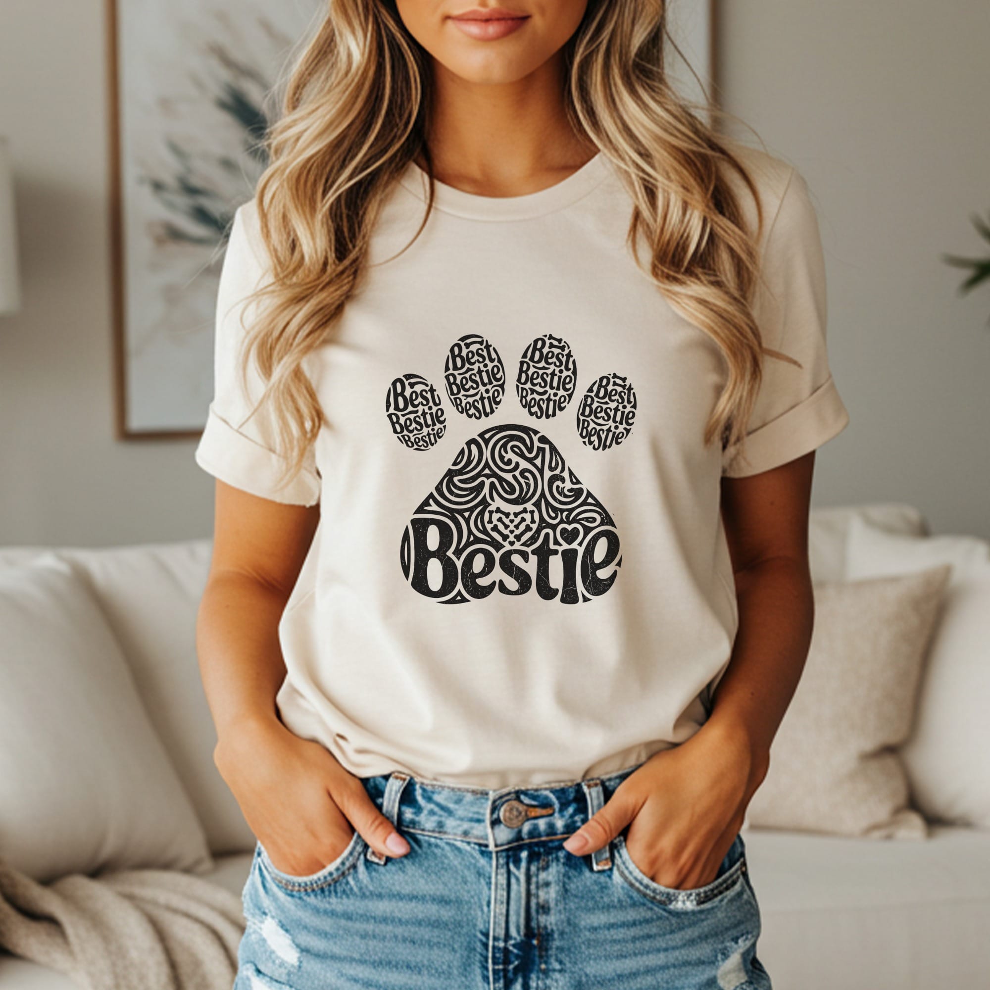 Cream t-shirt with black paw print graphic saying "Bestie" repeatedly.