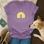 Purple t-shirt with a minimalist sunrise and dog silhouette design.