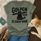 Olive green t-shirt with black text and dog silhouette holding stick.