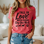 T-shirt with text "Fall in love with every dog you meet" and dog silhouettes.