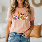Shirt with colorful illustration of dogs preparing for a beach vacation.