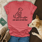Coral t-shirt with a dog outline and heart motif, text reads "Love Walks on Four Paws".
