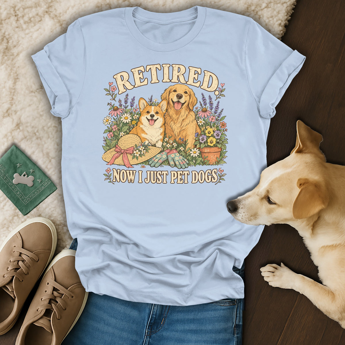 Light blue t-shirt featuring a graphic of two dogs and text reading RETIRED NOW I JUST PET DOGS.