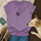 Purple t-shirt with a dandelion silhouette transforming into paw prints.
