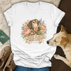 White v-neck t-shirt featuring a vintage illustration of a senior dog, flowers, and the text fewer years more love.