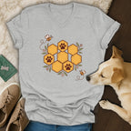 Gray V-neck t-shirt featuring a honeycomb graphic with paw prints, surrounded by bees and leaves.
