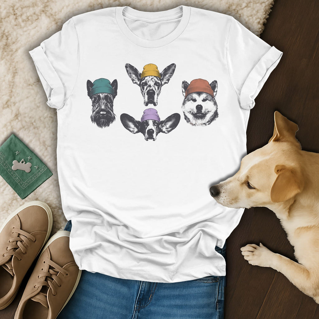 T-shirt with four dog portraits wearing beanies, laid flat with accessories.