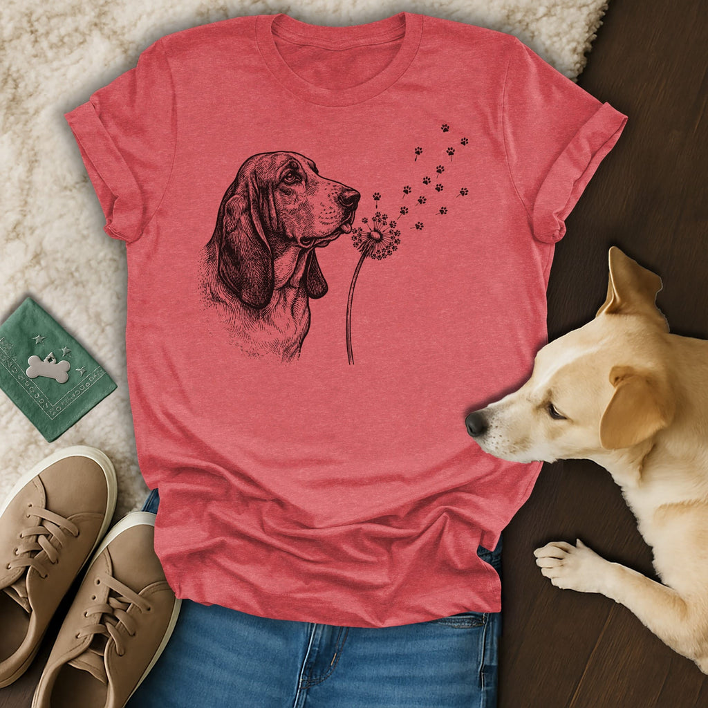 Red t-shirt with a black and white drawing of a basset hound blowing dandelion seeds.