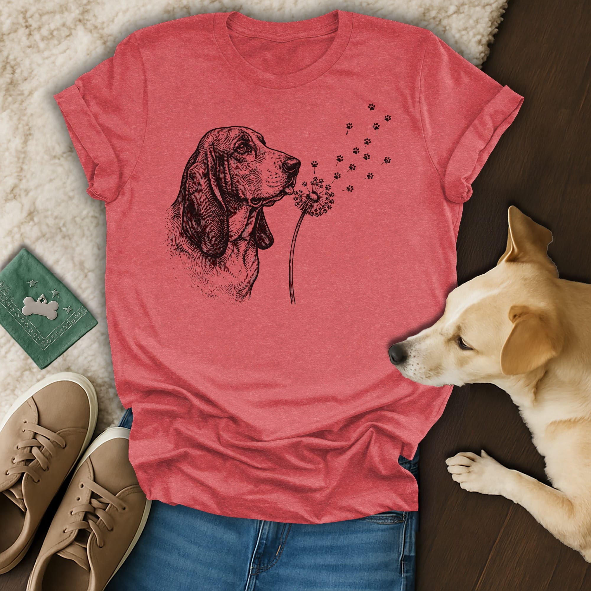 Red t-shirt with a black and white drawing of a basset hound blowing dandelion seeds.