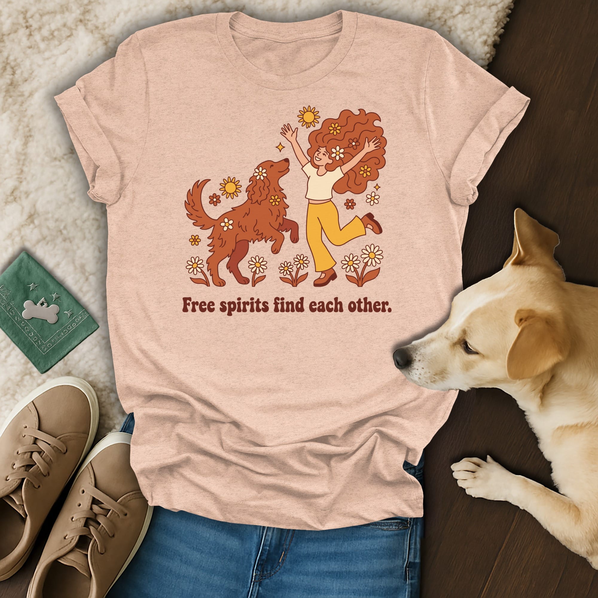 Peach t-shirt with retro illustration of people and dog, saying "Free spirits find each other."