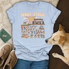Light blue t-shirt with "WOOF STOCK" text and a graphic of dogs at a music festival.