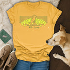 Yellow t-shirt with a tennis net and dog surrounded by balls, "40 - Love" text.