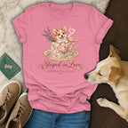 Pink t-shirt featuring a corgi in a teacup graphic with the text Steeped in Love, Corgis & Tea, Please.