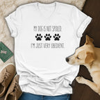 White V-neck t-shirt with text "MY DOG IS NOT SPOILED. I'M JUST VERY OBEDIENT." and paw prints.