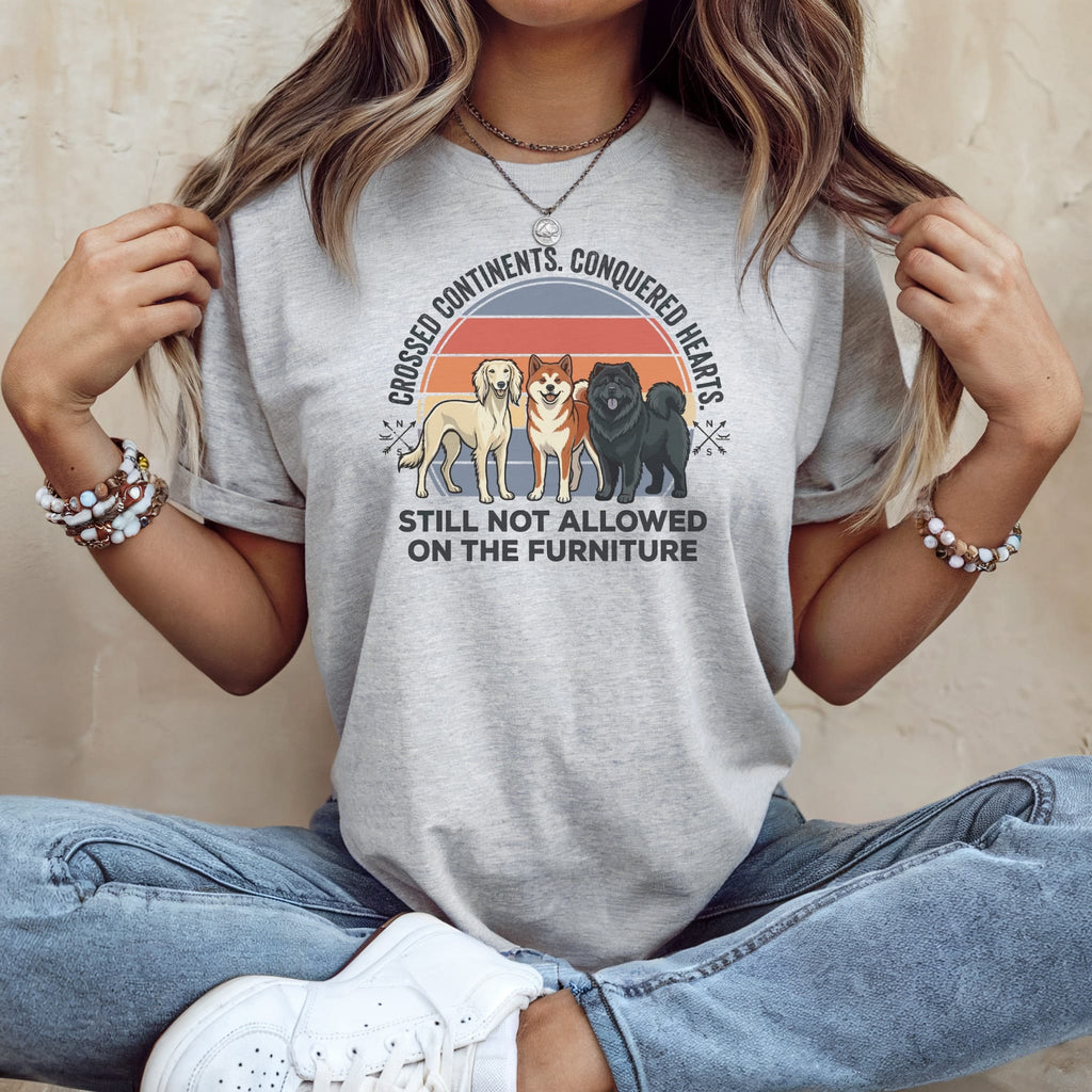 T-shirt with three dogs and text "crossed continents, conquered hearts still not allowed on the furniture".
