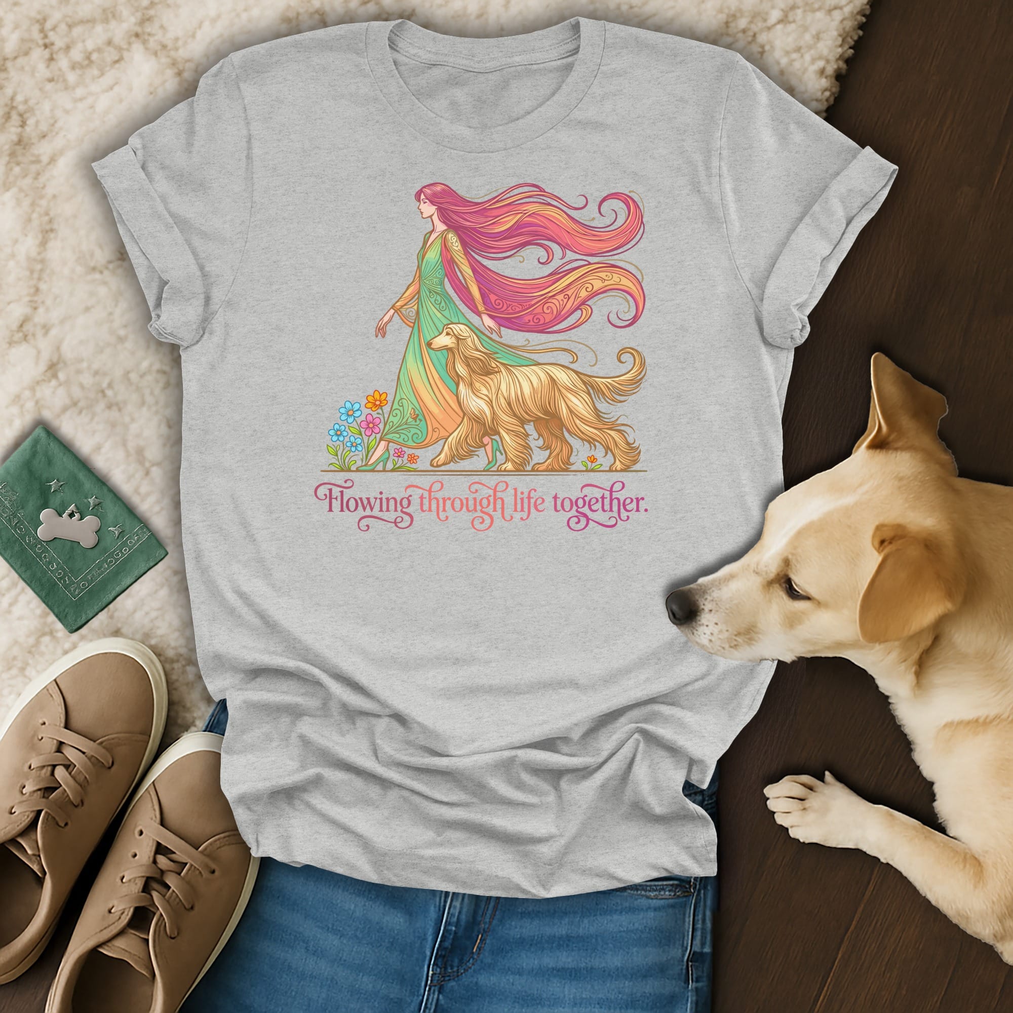 Grey t-shirt with woman and dog graphic, surrounded by flowers.