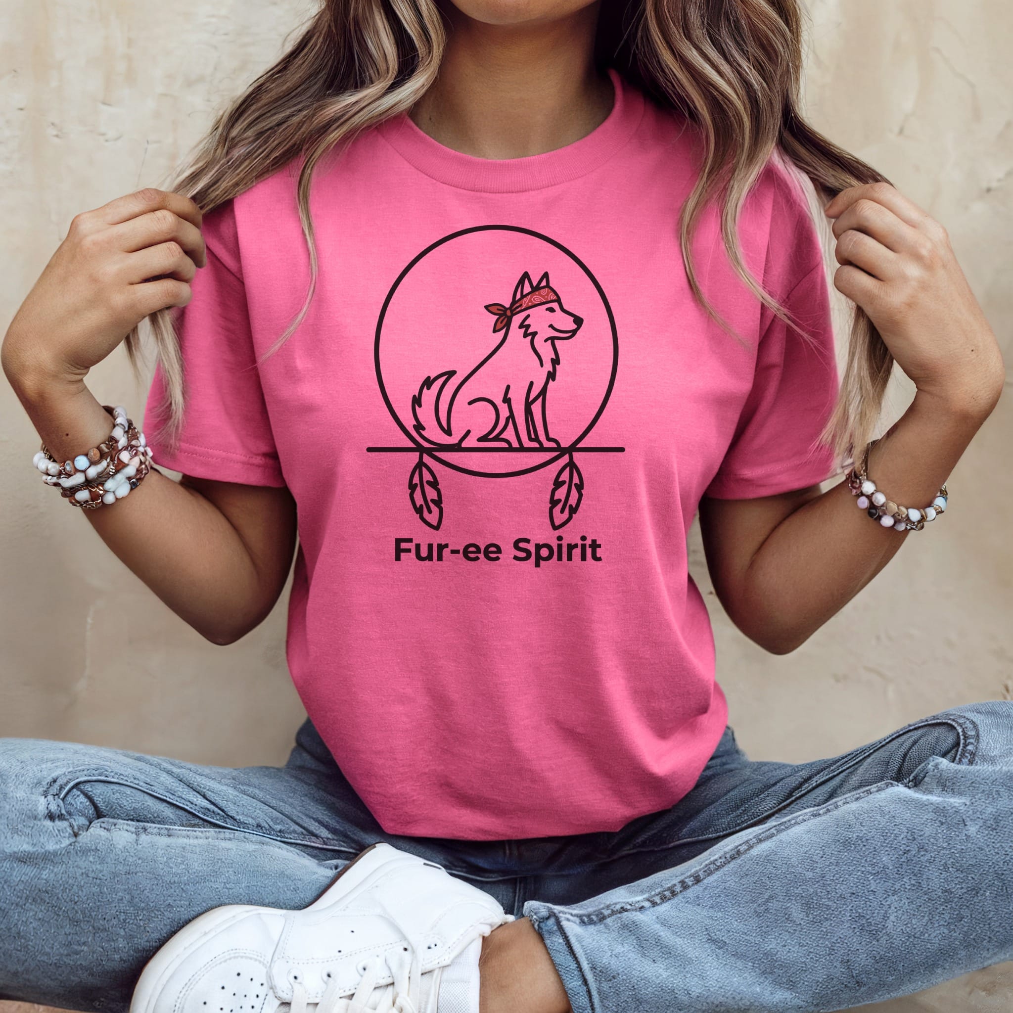 Pink t-shirt with a circular graphic of a wolf and the text "Fur-ee Spirit".