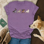 Purple t-shirt with four dogs in Halloween costumes: witch, mummy, vampire, ghost.