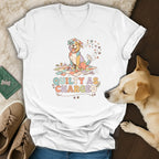 White t-shirt with a colorful dog sitting on a quilt and the text "QUILTY AS CHARGED".
